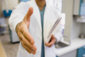 Doctor Shaking Hands --- Image by © Bill Varie/Somos Images/Corbis